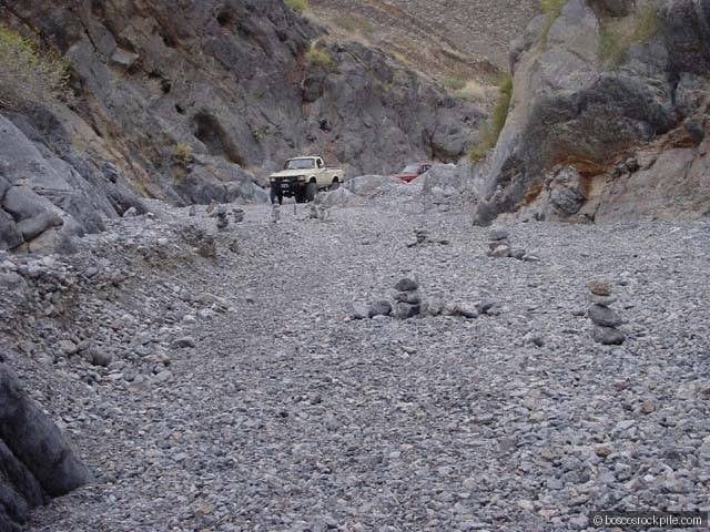 Expedition vehicles staged in a Death Valley canyon — the logistics of working one of North America's harshest field environments.