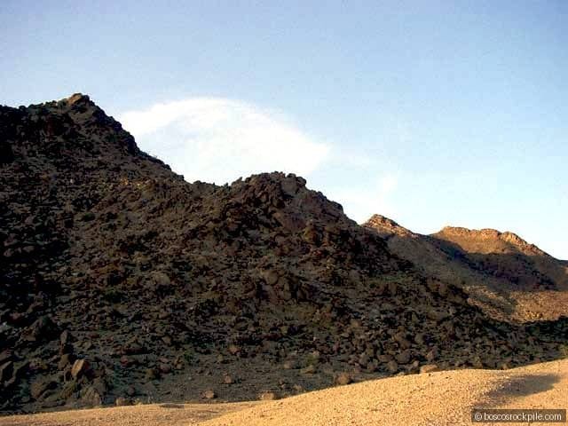 Volcanic mountains catching golden-hour light above the valley floor.