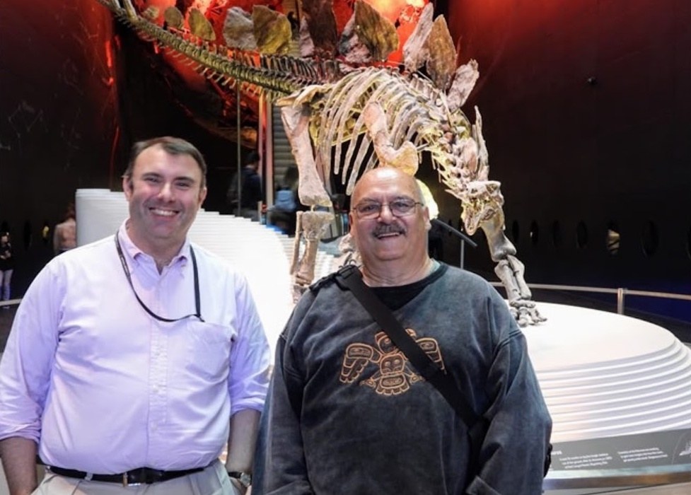 Bosco with Dr. Paul Barrett in front of the mounted Sophie at the Natural History Museum, London